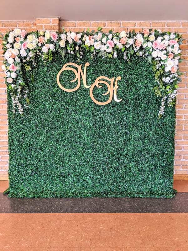 green hedge with top floral white pink arch